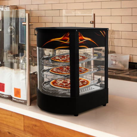 Three pizzas displayed in a black countertop pizza warmer with glass sides, featuring a flame design and stainless steel shelves