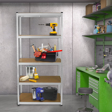 Metal shelving unit with four wooden shelves, filled with tools, a bucket, and a drill, set against a concrete wall and green workbench