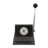 Heavy-duty badge maker with a textured black base, shiny silver circular press, and a long lever for easy operation
